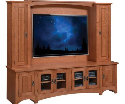 Entertainment hutch with large flat screen tv mounted in center with cabinets on each side and underneath
