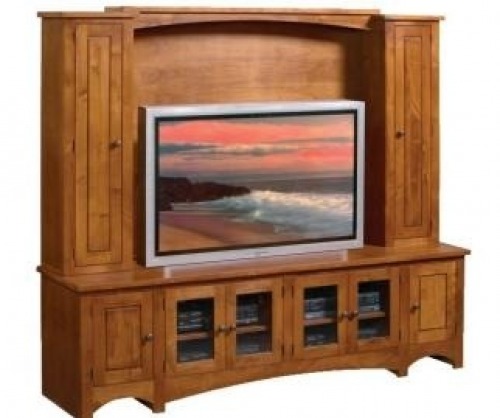 Entertainment hutch with large flat screen tv mounted in center with cabinets on each side and underneath