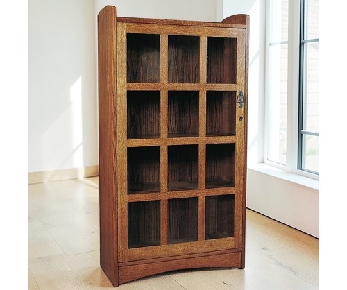 Blonde wooden display case with 12 nooks that can be used as drawers or just display shelves, glass doors with black hardware